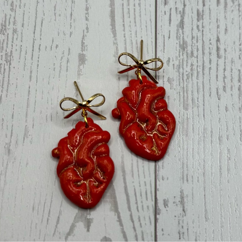 Red Anatomical Heart-Shaped Earrings with Gold Bow